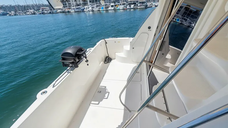 Slide: The Image of Spacious Aft Deck with Grill This aft deck area on the 2005 Meridian 540 Pilothouse offers ample space for outdoor enjoyment. Equipped with a built-in grill, it's perfect for alfresco dining while enjoying scenic views. The sleek railing and stair access enhance both safety and style - 7721621