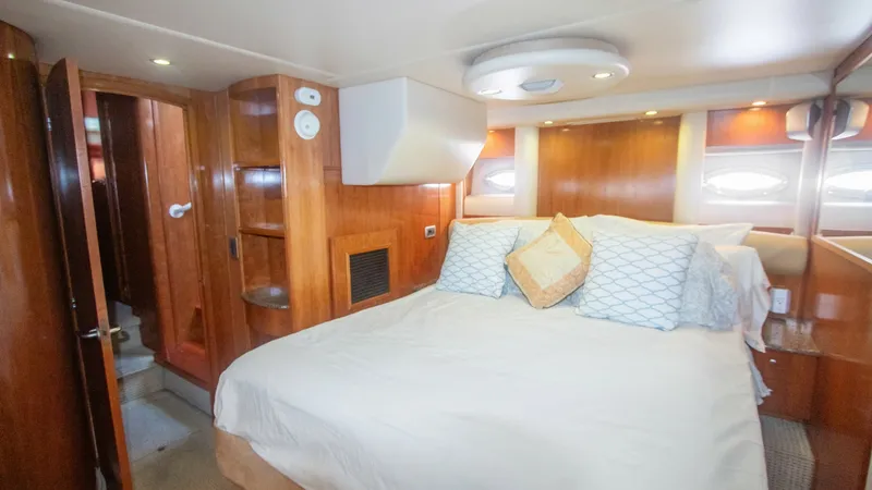 Slide: The Image of Master Stateroom with Ensuite Access The master stateroom of the 2005 Meridian 540 Pilothouse offers a spacious and inviting retreat. Featuring a large, plush bed with elegant bedding, this room is designed for ultimate comfort. Rich wood finishes and ample natural light from the side window - 7721593
