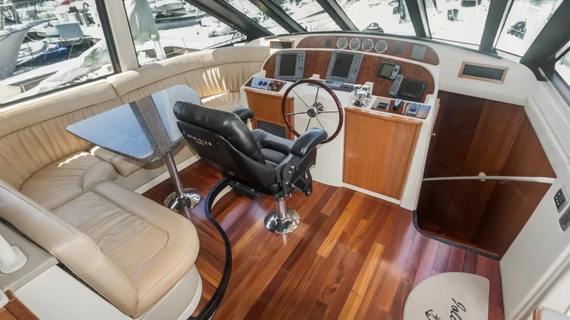 Slide: The Image of Pilothouse Helm with Seating Area The pilothouse of the 2005 Meridian 540 Pilothouse, JOLIE VIE, features a spacious helm with advanced navigation instruments and a comfortable captain's chair. The area includes a plush L-shaped leather seating arrangement and a stylish table, perfect for - 7721596