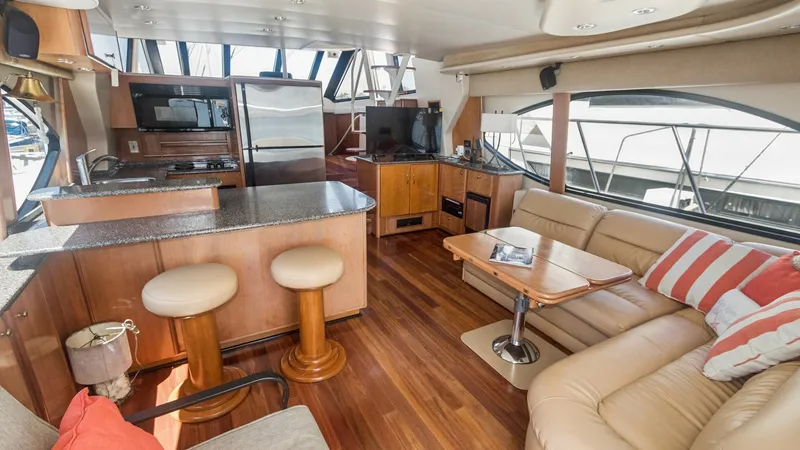 Slide: The Image of Spacious Salon with Galley View This inviting salon aboard the 2005 Meridian 540 Pilothouse features a luxurious L-shaped leather sofa and a polished wood coffee table, ideal for relaxation and entertaining. The open-concept layout seamlessly connects to the fully equipped galley, showc - 7721591