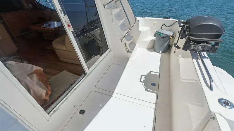 Slide: The Image of Spacious Aft Deck with Grill This image showcases the aft deck of the 2005 Meridian 540 Pilothouse, featuring ample space for outdoor activities. The deck is equipped with a convenient grill, perfect for alfresco dining while enjoying scenic views. The sliding glass door provides eas - 7721623