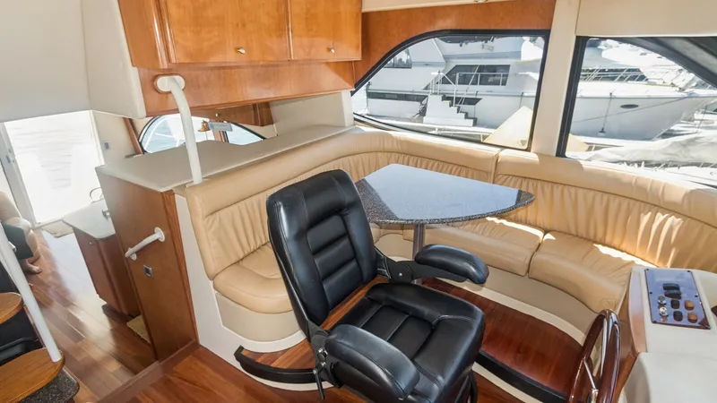 Slide: The Image of Pilothouse Helm and Seating Area The pilothouse of the 2005 Meridian 540 Pilothouse, JOLIE VIE, features a well-appointed helm with a plush captain's chair and a curved seating area. The space is enhanced by rich wood finishes and large windows, offering excellent visibility and natural - 7721595