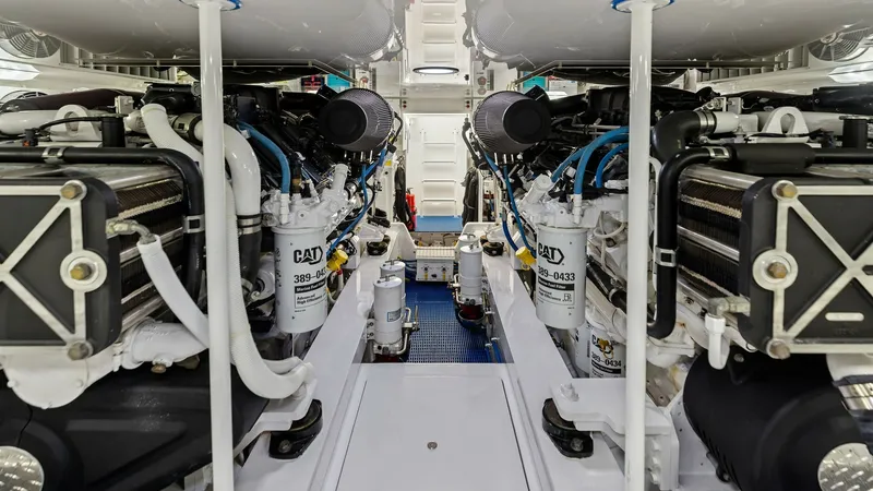 Slide: The Image of Engine Room with Twin Engines This image showcases the pristine engine room of the 2018 Viking 62 Enclosed Bridge, featuring powerful twin engines. The layout is meticulously organized with easy access for maintenance, highlighting the vessel's commitment to performance and reliabilit - 7751298