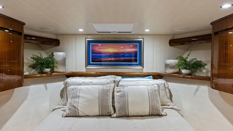Slide: The Image of Luxurious Forward Stateroom The forward stateroom of the 2018 Viking 62 Enclosed Bridge offers a luxurious retreat with its plush bedding and ambient lighting. Rich wood finishes and elegant decor provide a warm and inviting atmosphere. The space is highlighted by a striking piece o - 7751251