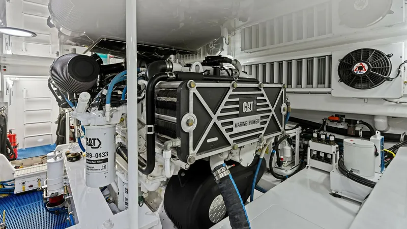 Slide: The Image of Engine Room with CAT Marine Power The engine room of the 2018 Viking 62 Enclosed Bridge showcases powerful CAT Marine Power engines. This space is impeccably maintained, featuring organized systems and easy access for maintenance. The clean, well-lit environment ensures optimal performanc - 7751296