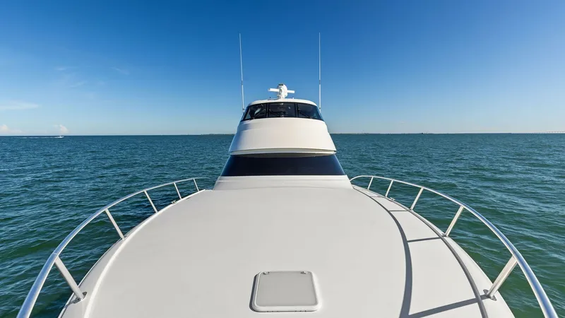 Slide: The Image of Forward Deck and Enclosed Bridge View The forward deck of the 2018 Viking 62 Enclosed Bridge offers a spacious and sleek design, ideal for enjoying open water vistas. The sturdy railings ensure safety while navigating or relaxing on deck. The enclosed bridge provides a commanding view, highli - 7751289