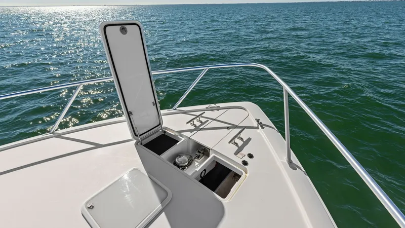 Slide: The Image of Foredeck Anchor Locker Access The foredeck of the 2018 Viking 62 Enclosed Bridge offers easy access to the anchor locker, featuring a sleek hatch design. The sturdy stainless steel railing enhances safety while navigating open waters. The clean lines and practical layout provide a fun - 7751288