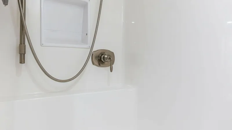 Slide: The Image of Sleek Shower Fixture The shower area of the 2018 Viking 62 Enclosed Bridge features a modern, stainless steel fixture and an integrated storage niche. The sleek design and high-quality materials ensure a luxurious and functional space. The bright white finish adds to the clea - 7751244
