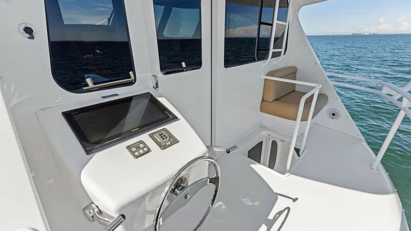 Slide: The Image of Upper Helm Station with Seating This image showcases the upper helm station of the 2018 Viking 62 Enclosed Bridge. The helm features a sleek, modern console with advanced navigational technology and a comfortable captain's chair. Adjacent seating provides an ideal spot for relaxation, o - 7751286
