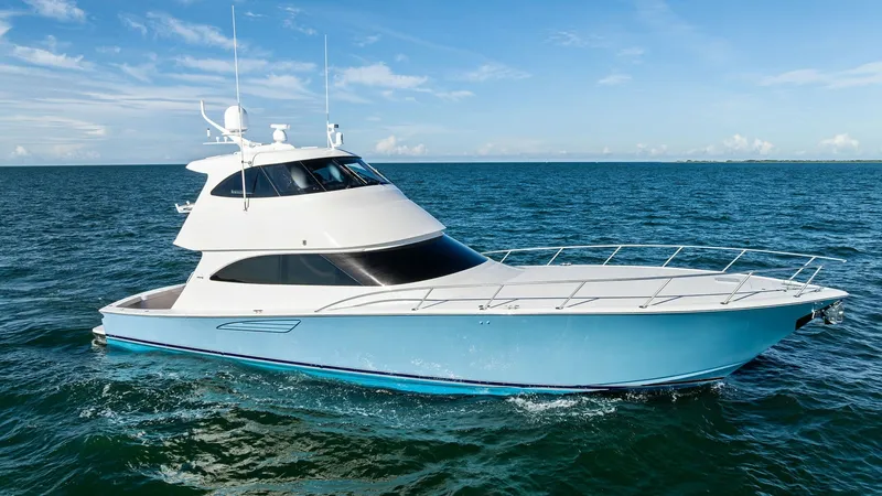 Slide: The Image of Starboard View of 62 Enclosed Bridge This image showcases the sleek starboard side of the 2018 Viking 62 Enclosed Bridge, featuring a striking blue hull and streamlined design. The enclosed bridge offers enhanced visibility and protection, ideal for navigating various conditions. With its sp - 7751307