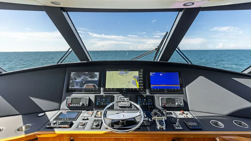 Slide: The Image of Helm Station with Ocean View The helm station of the 2018 Viking 62 Enclosed Bridge offers a panoramic ocean view through expansive windows. Equipped with state-of-the-art navigation systems, including multiple multifunction displays and advanced controls, it ensures a superior pilot - 7751284