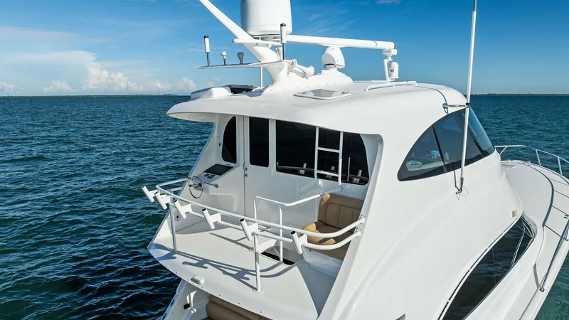 Slide: The Image of Enclosed Bridge and Upper Deck View This image showcases the sleek enclosed bridge of the 2018 Viking 62 Enclosed Bridge model. The upper deck offers a commanding view of the surroundings and features comfortable seating, perfect for navigating or relaxing. The modern radar and communicatio - 7751313