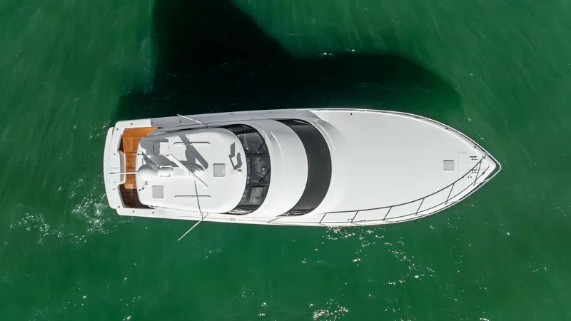 Slide: The Image of Aerial View of Viking 62 Enclosed Bridge This aerial shot captures the sleek design of the 2018 Viking 62 Enclosed Bridge, 'Joan's Boys'. The yacht's spacious bow and enclosed bridge provide optimal visibility and weather protection. The vessel's streamlined profile and ample deck space are perf - 7751311