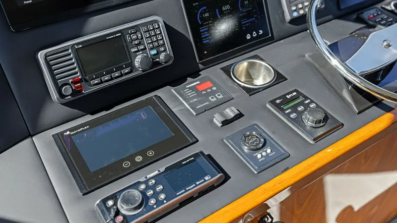 Slide: The Image of Helm Station with Advanced Electronics The helm station of the 2018 Viking 62 Enclosed Bridge showcases a sophisticated array of advanced navigation and communication equipment. Featuring a sleek console with intuitive controls, the setup includes a range of touch-screen displays and multifunc - 7751276