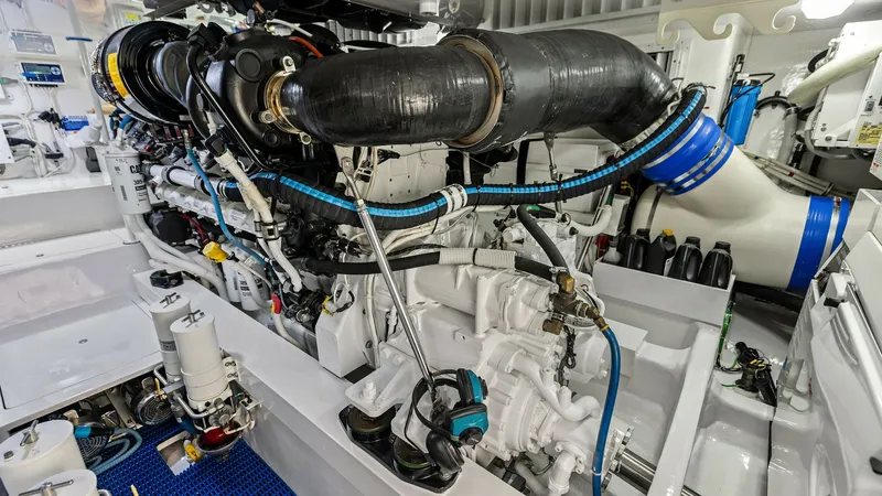 Slide: The Image of Engine Room with Advanced Machinery This image showcases the meticulously maintained engine room of the 2018 Viking 62 Enclosed Bridge. The space is equipped with state-of-the-art machinery, emphasizing efficiency and reliability. The clean layout and organized systems highlight the vessel' - 7751291