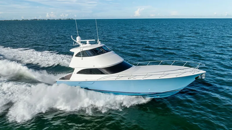 Slide: The Image of Dynamic Bow View at Sea This image captures the sleek and powerful bow of the 2018 Viking 62 Enclosed Bridge, 'Joan's Boys', cutting through the open water. The yacht's streamlined design and pristine white hull are accentuated by the surrounding ocean, showcasing its superior p - 7751315