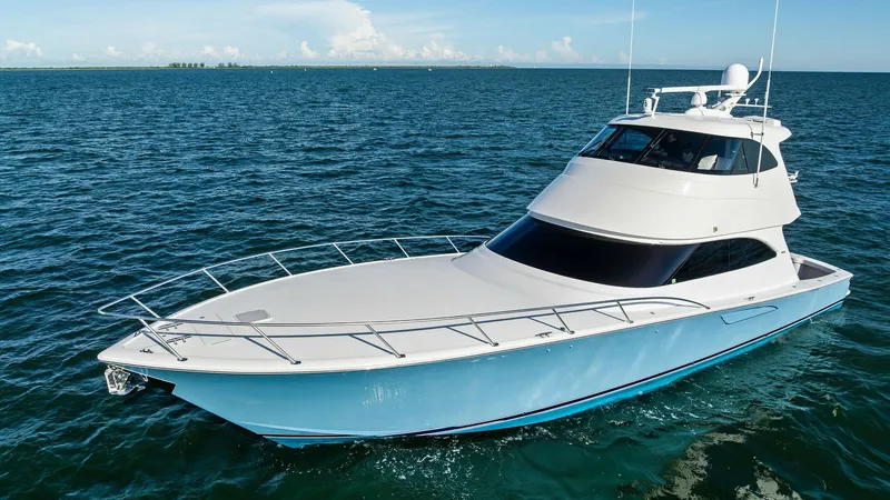 Slide: The Image of Bow View of Viking 62 Enclosed Bridge The Viking 62 Enclosed Bridge showcases a sleek, modern design with a spacious foredeck and a streamlined profile. The bright blue hull complements the expansive windows, offering stunning panoramic views. Equipped with advanced navigation systems, this v - 7751303