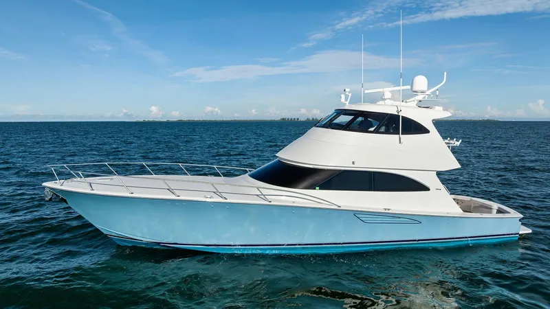 Slide: The Image of Portside View of Viking 62 Enclosed Bridge This image showcases the sleek and elegant design of the Viking 62 Enclosed Bridge, highlighting its aerodynamic hull and sophisticated profile. The vessel's expansive deck space and modern lines are complemented by large tinted windows, offering panorami - 7751304