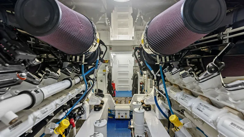 Slide: The Image of Engine Room with Dual Engines This image showcases the meticulously organized engine room of the Viking 62 Enclosed Bridge. Featuring dual high-performance engines, the space is designed for optimal functionality and accessibility. The clean layout and advanced engineering reflect the - 7751299
