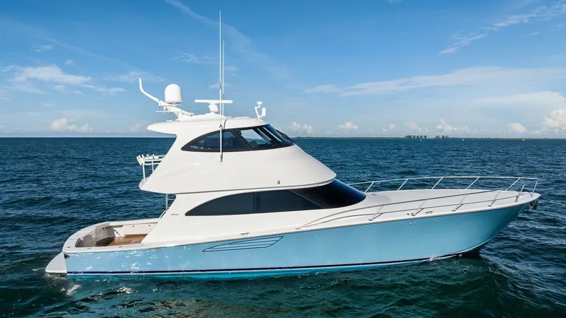 The Image of Starboard View of Enclosed Bridge This image showcases the sleek starboard profile of the 2018 Viking 62 Enclosed Bridge. The vessel features a striking blue hull with a modern enclosed bridge, offering enhanced visibility and protection from the elements. The spacious foredeck and aerody - 7751201