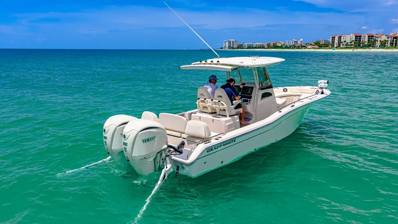 Slide: The Image of Aft View with Dual Engines This 2024 Grady-White 281 CE showcases its impressive dual Yamaha outboard engines, providing robust power for smooth cruising. The spacious aft deck includes comfortable seating, ideal for leisure or fishing excursions. The sleek design and polished fini - 7766865