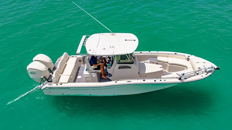 Slide: The Image of Aerial View of Grady-White 281 CE This image showcases the sleek design of the 2024 Grady-White 281 CE, highlighting its spacious deck layout and modern amenities. The dual outboard engines promise powerful performance, while the center console offers easy access and excellent visibility. - 7766867