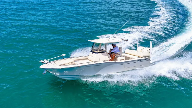 Slide: The Image of Grady-White 281 CE Cruising The 2024 Grady-White 281 CE is pictured cruising gracefully, showcasing its sleek hull design and powerful performance on open waters. The spacious deck offers ample seating and comfort, perfect for both leisure and fishing excursions. With its sturdy T-t - 7766905