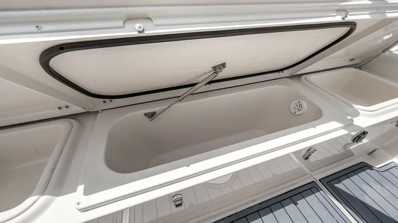 Slide: The Image of Spacious Fish Box with Drainage The 2024 Grady-White 281 CE features a generously sized fish box with efficient drainage, perfect for keeping your catch fresh. The lid is supported by a sturdy gas strut for easy opening and closing, ensuring convenience during fishing trips. The sleek, - 7766874