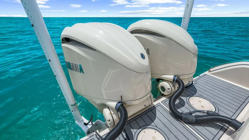 Slide: The Image of Twin Outboard Engines on Aft Deck This image showcases the powerful twin outboard engines of the 2024 Grady-White 281 CE, set against a stunning ocean backdrop. The robust engines are mounted on a sleek, non-slip aft deck, providing both safety and style. Ideal for high-performance boatin - 7766876