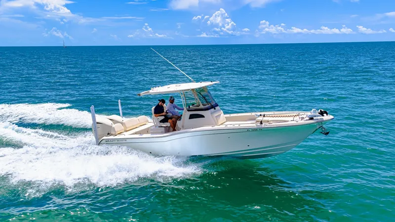 Slide: The Image of Grady-White 281 CE On Open Water The 2024 Grady-White 281 CE gracefully cuts through the water, showcasing its sleek hull and robust design. This model features a spacious center console with comfortable seating and advanced navigation equipment, perfect for both fishing and leisure. Its - 7766897