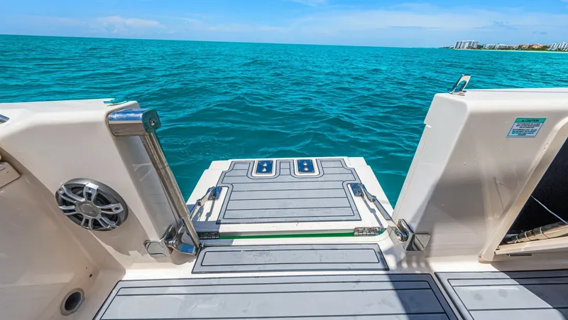 Slide: The Image of Stern Swim Platform with Ladder Experience seamless water access with the Grady-White 281 CE's spacious stern swim platform. This area features a robust, integrated swim ladder for easy boarding and non-slip decking for safety. The platform is ideal for water sports enthusiasts or those - 7766878
