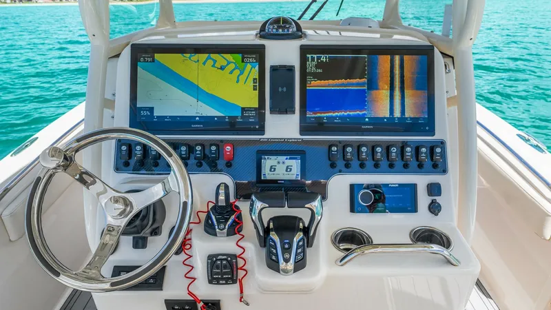 Slide: The Image of 2024 Grady-White 281 CE Helm Station with Advanced Electronics The helm station of the 2024 Grady-White 281 CE features state-of-the-art electronics, including dual multifunction displays for navigation and monitoring. The stainless-steel steering wheel and ergonomic controls ensure effortless handling, while the sle - 7766840