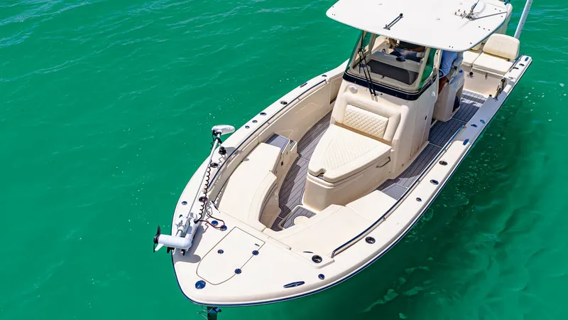 Slide: The Image of Bow and Helm Area Overview This image showcases the sleek bow and helm area of the 2024 Grady-White 281 CE. The spacious bow seating offers comfort and versatility, ideal for both relaxation and fishing activities. The helm is equipped with advanced navigation technology, sheltered - 7766847