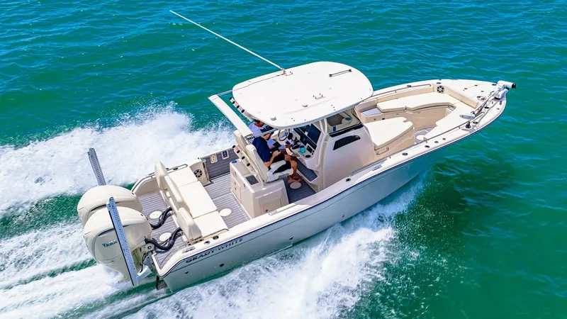 Slide: The Image of Aerial View of Grady-White 281 CE This image showcases the 2024 Grady-White 281 CE in action on open waters. The vessel features a sleek, modern design with a spacious center console and ample seating, offering comfort and functionality. Twin engines provide powerful performance, while th - 7766910