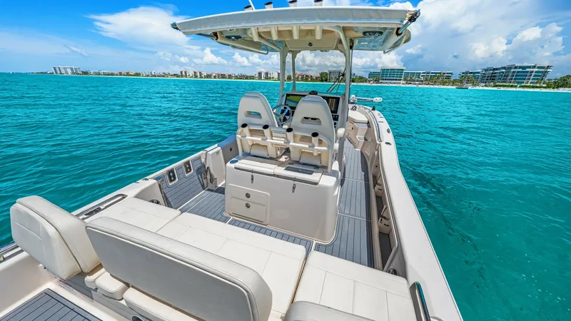 Slide: The Image of Spacious Cockpit with Helm Seating The 2024 Grady-White 281 CE features a spacious cockpit with plush, ergonomic helm seating, perfect for comfortable navigation. The deck is elegantly finished with high-quality, non-slip flooring, ensuring safety and style. Overhead, a sturdy T-top provid - 7766869