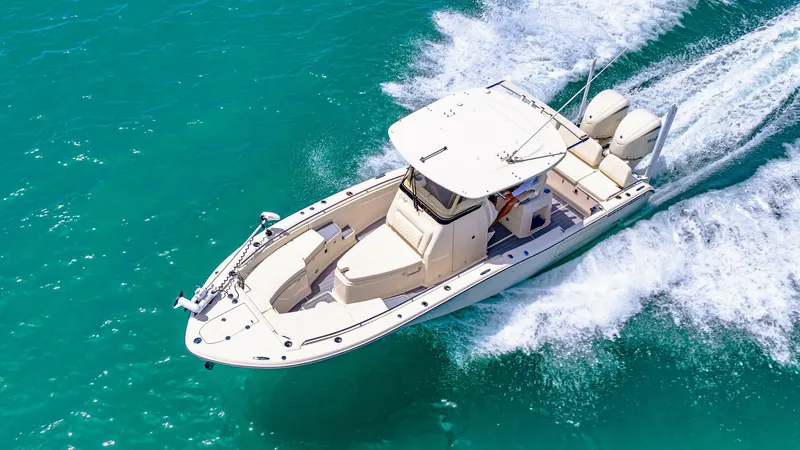 Slide: The Image of Aerial View of Grady-White 281 CE This stunning aerial image showcases the sleek design of the 2024 Grady-White 281 CE as it cuts through the water. The spacious bow area is equipped with comfortable seating, perfect for relaxation or casting a line. Twin outboard engines offer impressive - 7766907