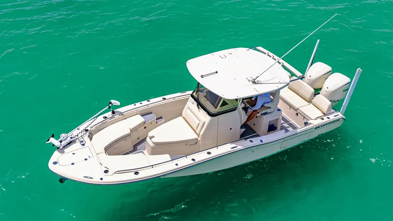 Slide: The Image of Aerial View of Grady-White 281 CE This aerial shot showcases the sleek design and spacious layout of the 2024 Grady-White 281 CE. The boat features a well-equipped helm station, ample seating, and twin outboard engines, perfect for both leisure cruising and fishing adventures. Its elegant - 7766846