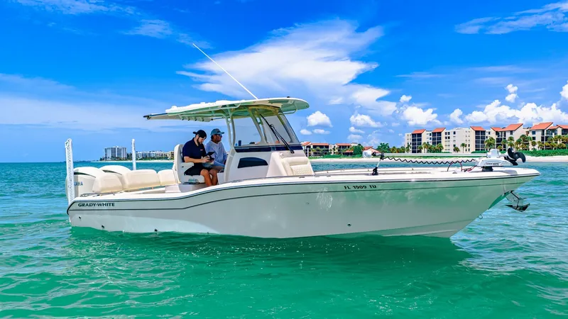 Slide: The Image of Side View of Grady-White 281 CE This image showcases the sleek side profile of the 2024 Grady-White 281 CE. The vessel features a spacious layout with a center console, offering ample seating for passengers. Its modern design and robust construction make it ideal for both leisure cruisi - 7766854