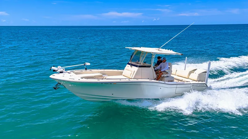 Slide: The Image of Grady-White 281 CE in Action The 2024 Grady-White 281 CE glides across the water, showcasing its sleek hull design and spacious deck. Equipped with advanced navigation tools and comfortable seating, this center console model is perfect for both leisure and sport. The vessel's elegant - 7766906