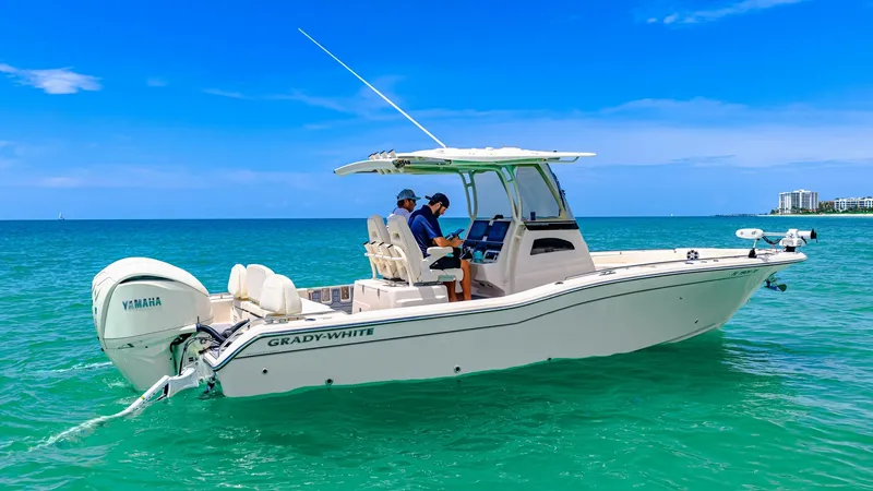 Slide: The Image of Starboard Profile of Grady-White 281 CE The 2024 Grady-White 281 CE is showcased in a serene marine setting, highlighting its sleek starboard profile. The boat features a robust Yamaha engine and a spacious helm area equipped with advanced navigation controls, ensuring a smooth and enjoyable ri - 7766866
