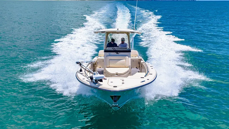 Slide: The Image of Front View Cruising on Open Water The 2024 Grady-White 281 CE is captured here in full throttle, cutting through the pristine blue waters with ease. The image showcases the boat's sleek hull design and spacious bow area, perfect for fishing or lounging. With its powerful engines and sturd - 7766901