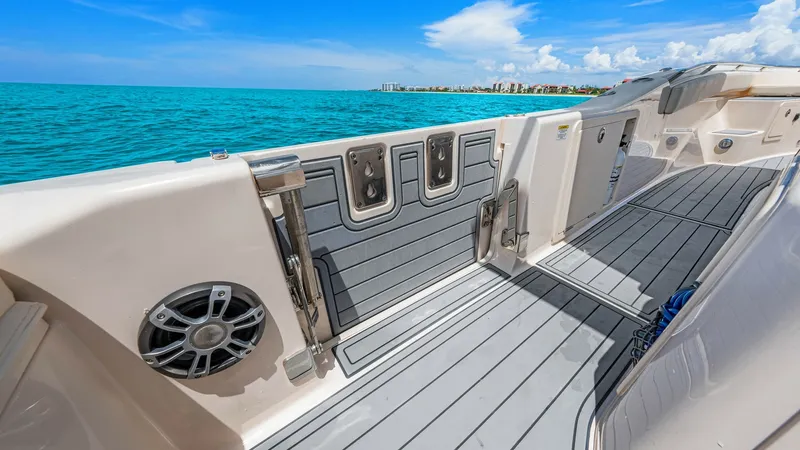 Slide: The Image of Spacious Aft Deck with Rod Holders The 2024 Grady-White 281 CE features a well-appointed aft deck, perfect for leisure and fishing activities. This area is equipped with integrated rod holders and non-slip decking for safety and convenience. The sleek design offers ample space, combining f - 7766877