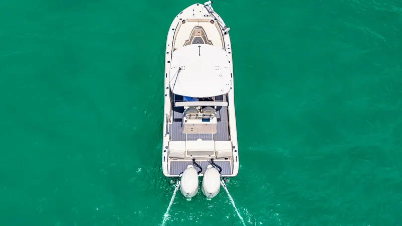 Slide: The Image of Aerial View of Aft Deck and Engines This aerial image showcases the Grady-White 281 CE's aft deck, highlighting its spacious layout and twin outboard engines. The clean lines and functional design offer ample space for fishing or relaxation, with a durable non-slip surface. The overhead vie - 7766859