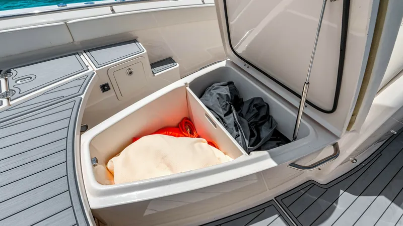Slide: The Image of Aft Deck Storage Compartment The aft deck of the 2024 Grady-White 281 CE features a spacious storage compartment, seamlessly integrated into the deck design. This area offers ample space for stowing gear, with easy access through a sturdy hatch. The deck's non-slip surface ensures sa - 7766895
