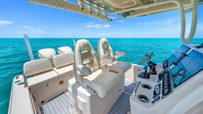 Slide: The Image of Helm and Cockpit Seating Area The 2024 Grady-White 281 CE features a luxurious helm with dual adjustable captain's chairs and a sleek control panel. The spacious cockpit area offers additional comfortable seating, perfect for leisurely cruising or entertaining. High-quality materials - 7766884
