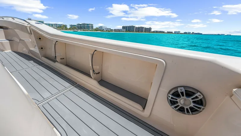 Slide: The Image of Starboard Deck with Storage The 2024 Grady-White 281 CE features a sleek starboard deck equipped with integrated storage compartments, perfect for securing gear. The deck boasts a non-slip surface, ensuring safety and comfort for all aboard. A built-in speaker enhances the outdoor e - 7766880