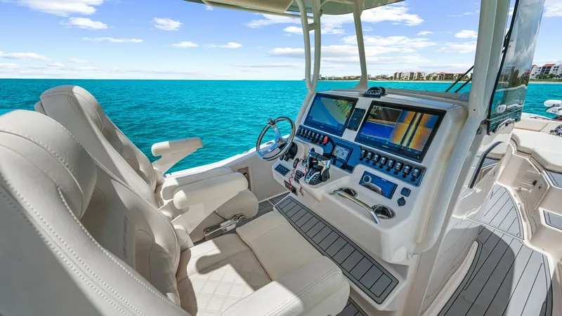 Slide: The Image of 2024 Grady-White 281 CE Helm Station with Dual Displays The helm station of the 2024 Grady-White 281 CE features state-of-the-art dual navigation displays, providing precise control and convenience. Luxurious seating ensures comfort for long voyages, while the intuitive layout enhances the captain's experience - 7766841