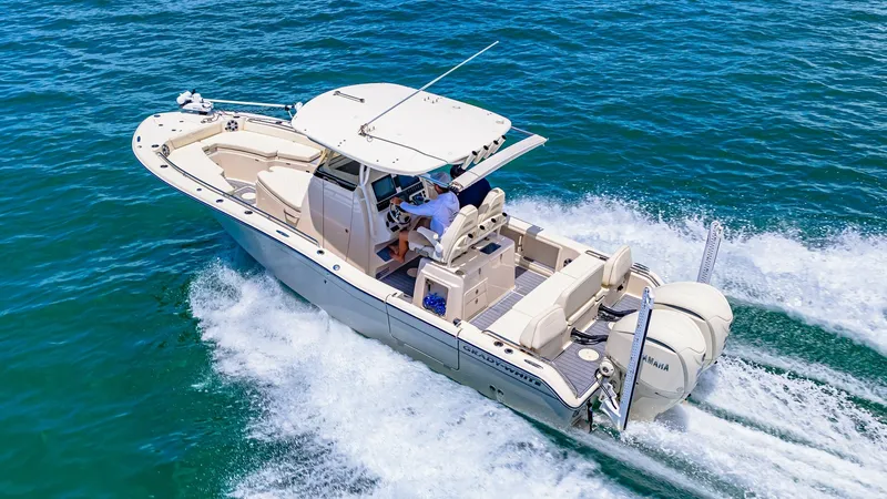 Slide: The Image of Aerial View of Grady-White 281 CE This aerial shot showcases the sleek design and spacious layout of the 2024 Grady-White 281 CE. The vessel is equipped with powerful twin Yamaha outboard engines, providing impressive speed and efficiency on the water. The cockpit features ample seating a - 7766908