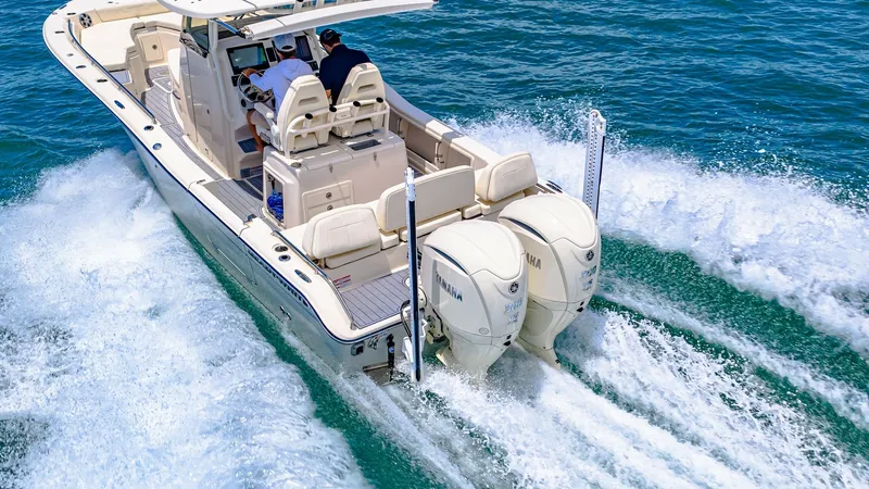 Slide: The Image of Aft Deck and Dual Outboards The Grady-White 281 CE's aft deck showcases spacious seating and dual Yamaha outboards for powerful performance. The sleek design and comfortable helm station provide an ideal setup for both leisure cruising and fishing. The boat's elegant lines and effic - 7766911