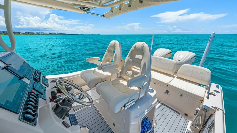 Slide: The Image of Helm and Cockpit Seating Area This image showcases the helm and cockpit seating area of the 2024 Grady-White 281 CE. The helm is equipped with state-of-the-art navigation systems and a sleek, ergonomic design, providing optimal control and comfort. The plush seating offers ample space - 7766883